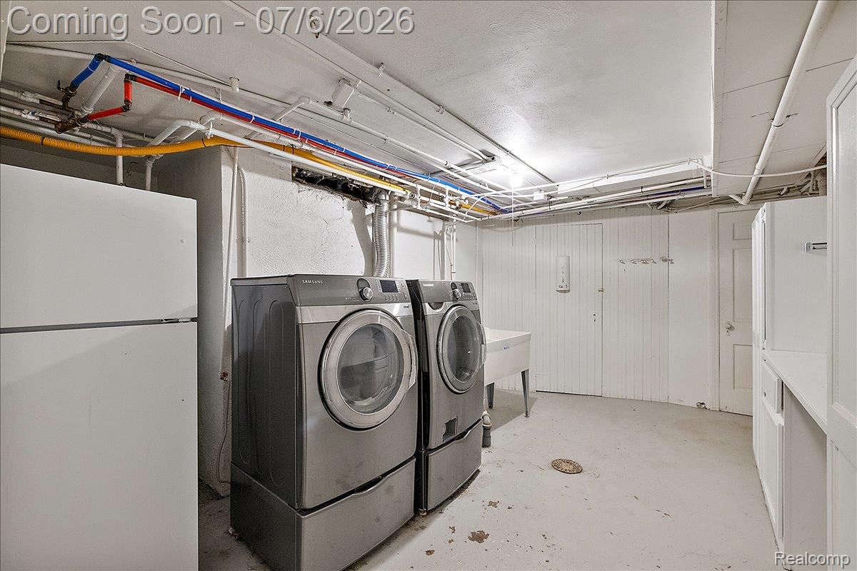 1051 Devonshire Road Grosse Pointe, MI 48230 - Photo 80 of 98 Dedicated utility space featuring exposed ceiling utilities, a white utility sink, white paneled walls, and white cabinetry with a countertop