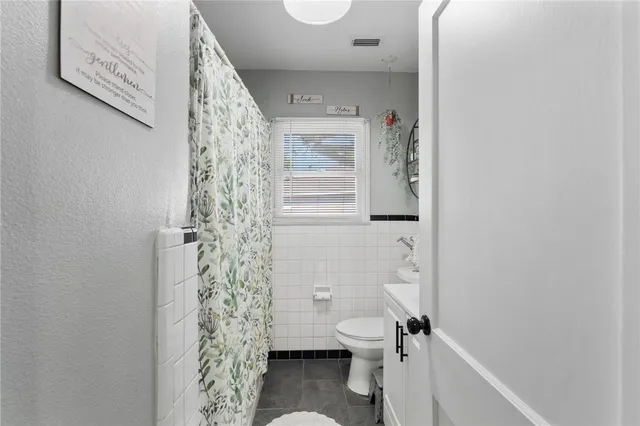 a bathroom with a toilet and shower