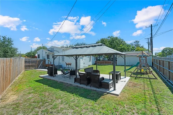 a view of a house with backyard porch and sitting area