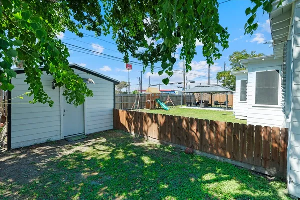 a view of a house with wooden fence