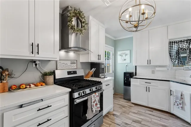 a kitchen with stainless steel appliances a stove and cabinets