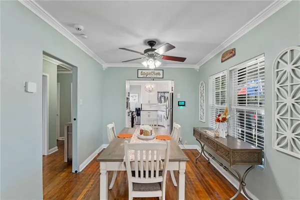a view of a dining room with furniture window and wooden floor