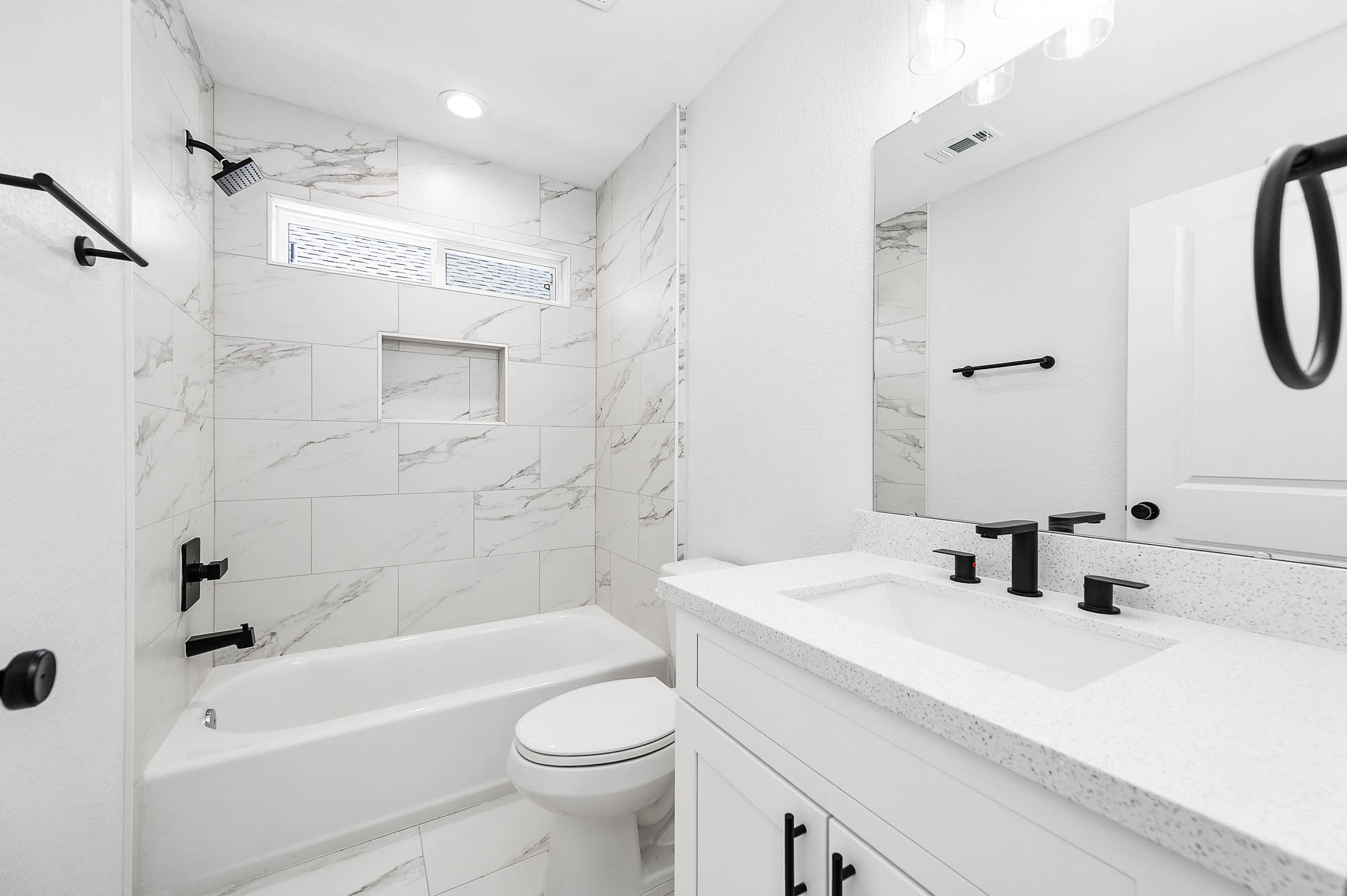 2024 Hampton Street, Unit A B Houston, TX 77088 - Photo 24 of 31 a bathroom with a sink a toilet a mirror a bathtub and shower