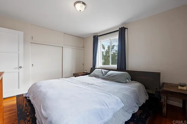 a bedroom with a bed and a window