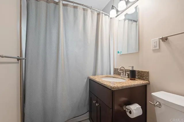 a white toilet sitting next to a bathroom sink