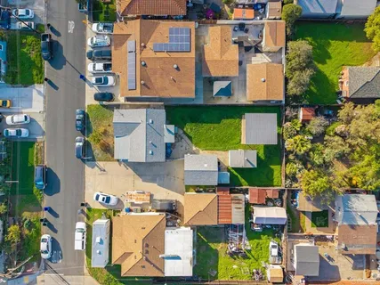 an aerial view of residential houses with outdoor space