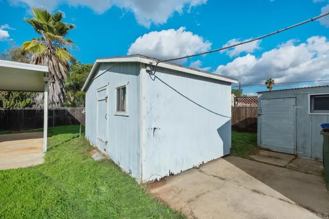 a white house with a small yard and a large space