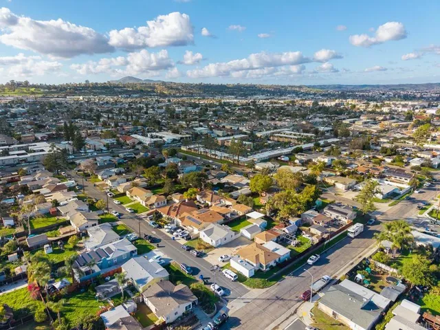 an aerial view of residential houses with city view