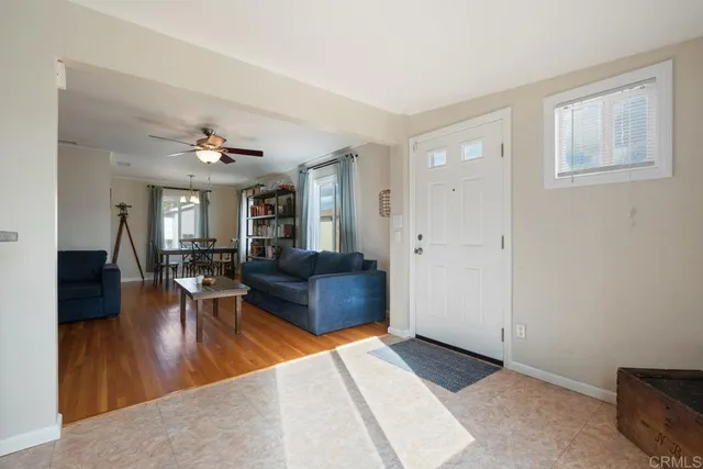 a living room with couches and view of living room