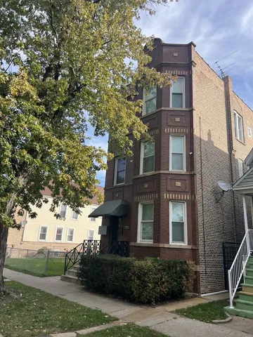 a front view of a residential apartment building with a yard