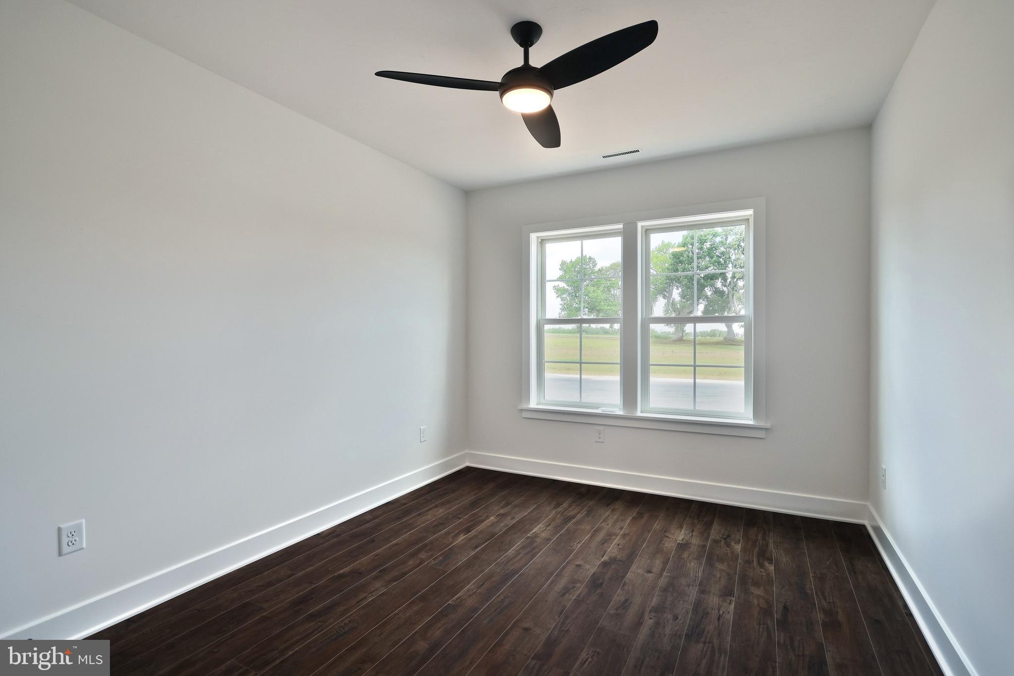 559 Lumber Street Littlestown, PA 17340 - Photo 16 of 73 an empty room with wooden floor ceiling fan and windows