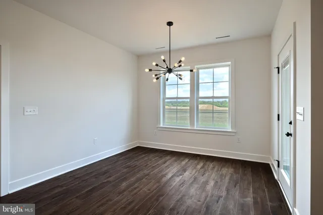 a view of kitchen with cabinets and wooden floor