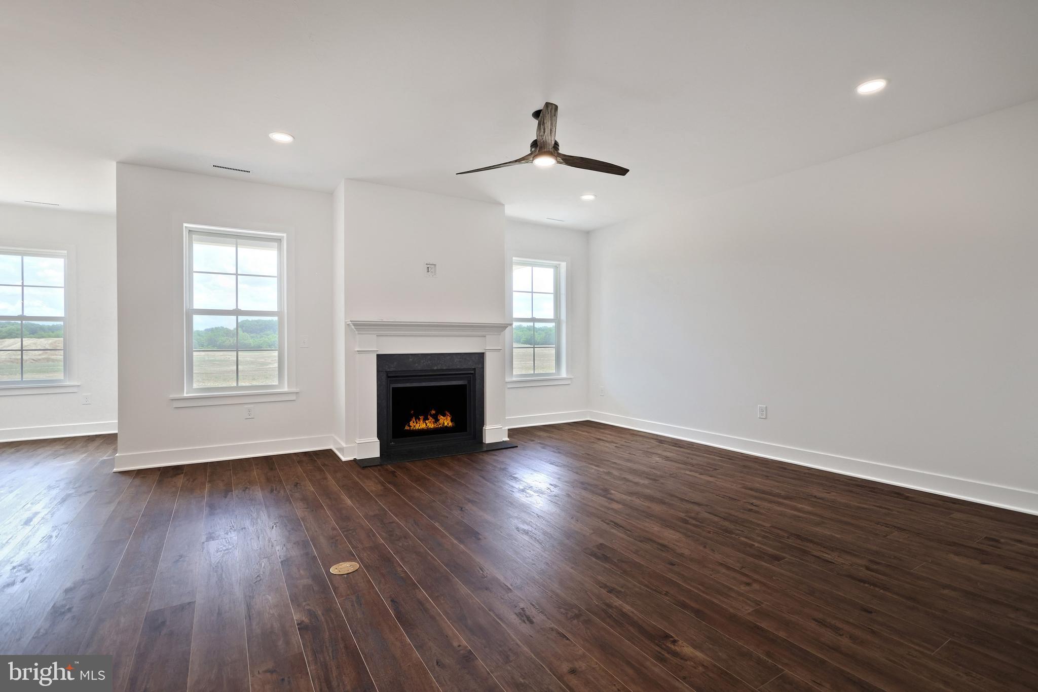 559 Lumber Street Littlestown, PA 17340 - Photo 22 of 73 a view of an empty room with wooden floor fireplace and a window