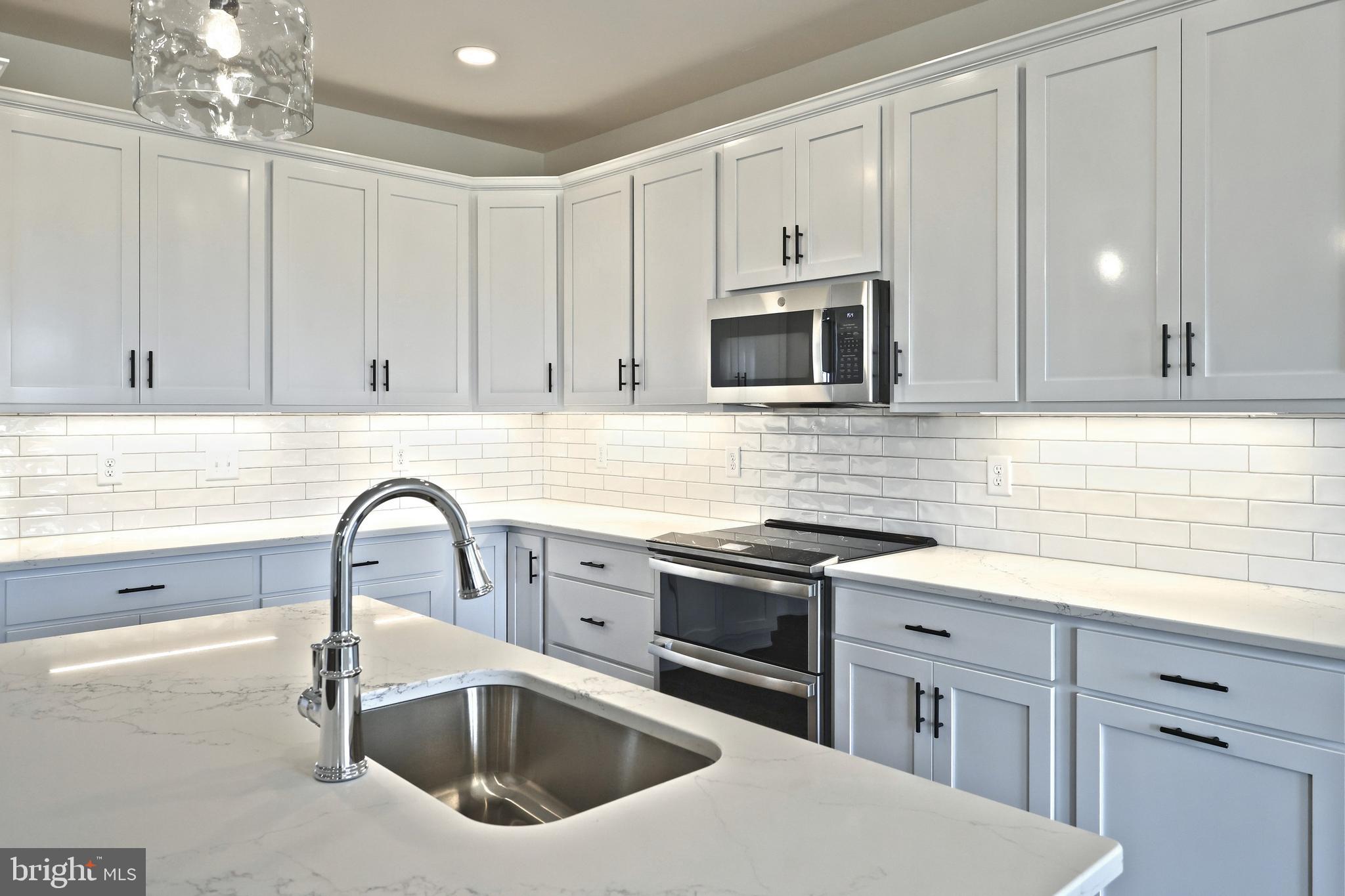 559 Lumber Street Littlestown, PA 17340 - Photo 25 of 73 a kitchen with granite countertop a sink stainless steel appliances and cabinets