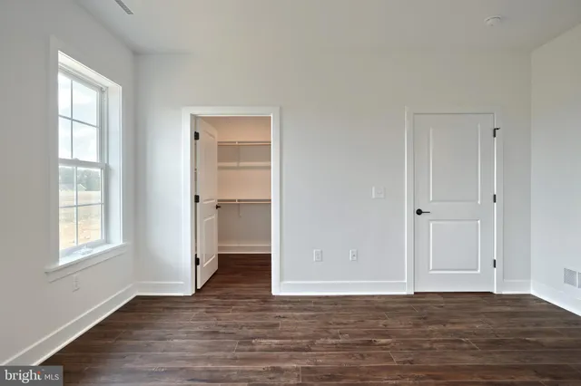 a front view of a house with a garden and garage