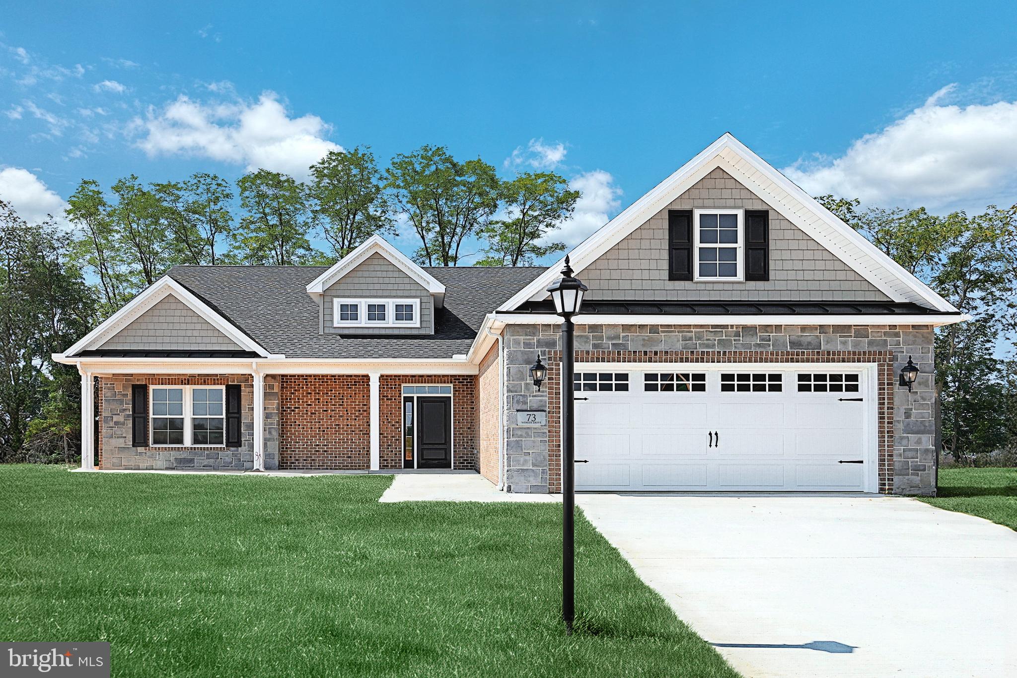 559 Lumber Street Littlestown, PA 17340 - Photo 46 of 73 a front view of a house with a garden and garage