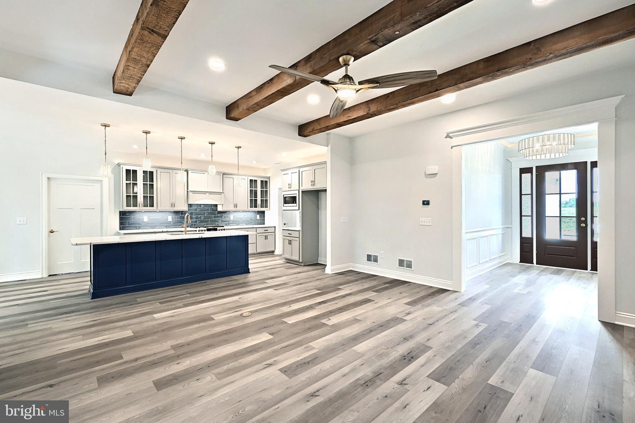 559 Lumber Street Littlestown, PA 17340 - Photo 60 of 73 a large room with stainless steel appliances kitchen island wooden floors and view living room
