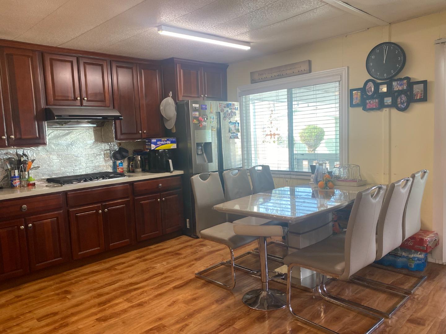 2580 Senter Road, Unit 424 San Jose, CA 95111 - Photo 11 of 12 a kitchen with granite countertop a stove a sink cabinets and wooden floor