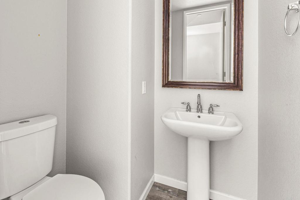 3848 Lake Park Street Fallbrook, CA 92028 - Photo 13 of 35 a bathroom with a toilet sink and mirror