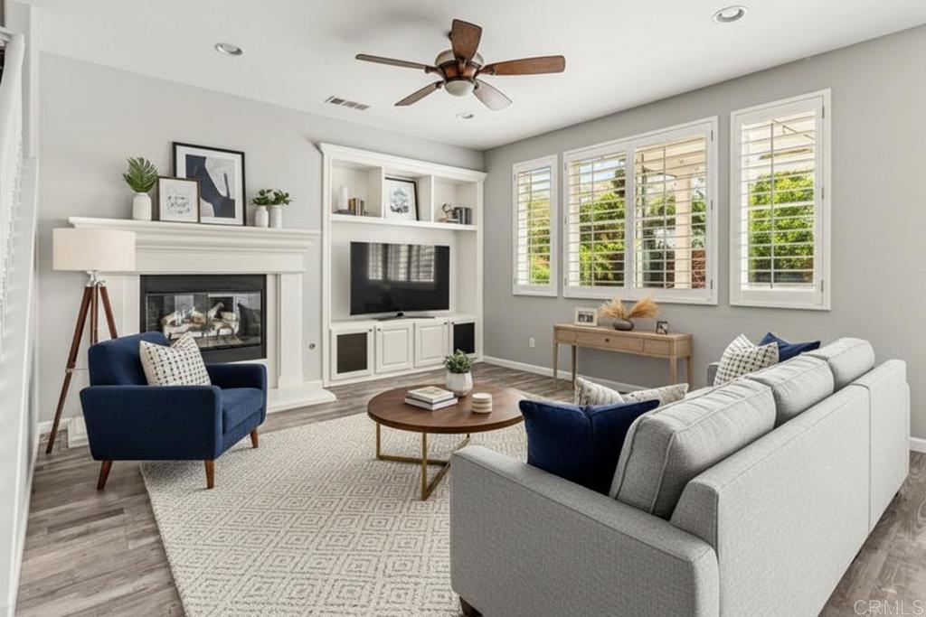 3848 Lake Park Street Fallbrook, CA 92028 - Photo 14 of 35 a living room with furniture a fireplace and a flat screen tv