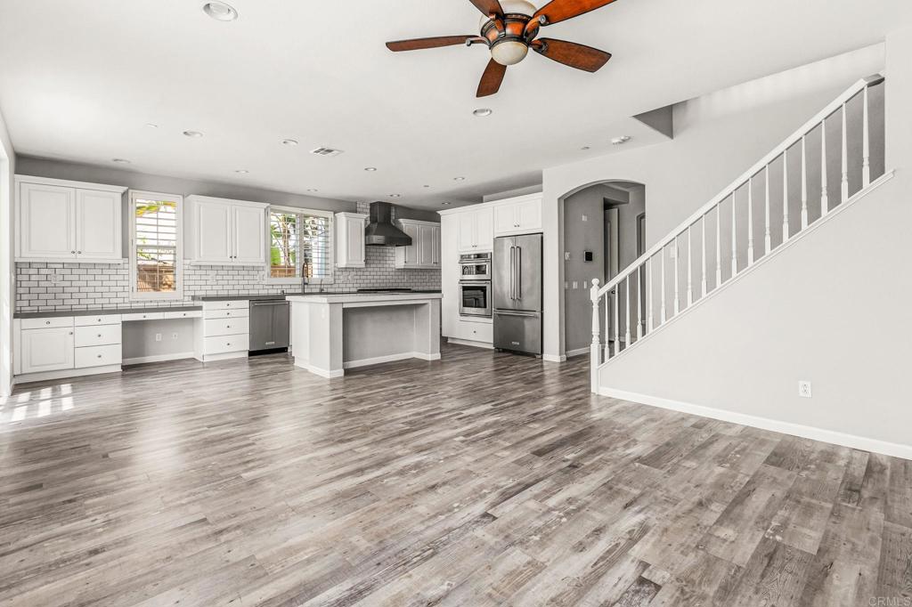 3848 Lake Park Street Fallbrook, CA 92028 - Photo 16 of 35 a view of a kitchen with wooden floor a sink a refrigerator and window