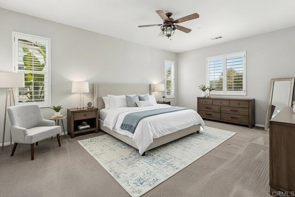 3848 Lake Park Street Fallbrook, CA 92028 - Photo 22 of 35 a bedroom with a large bed a couch and windows