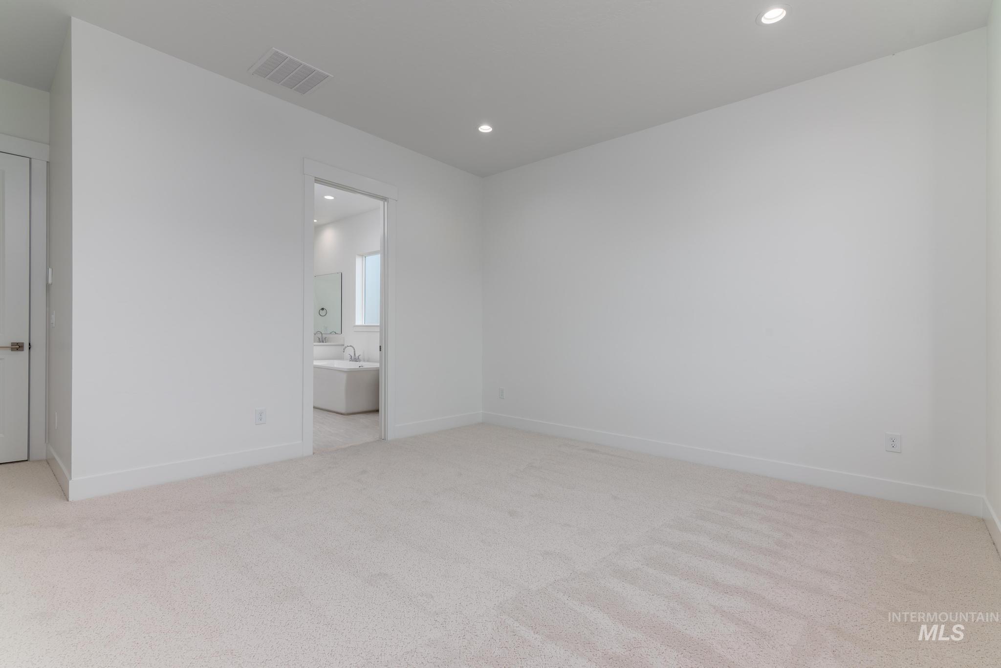 5403 Juliet Rose Avenue Caldwell, ID 83607 - Photo 8 of 12 Spacious carpeted room featuring recessed lighting and white baseboards