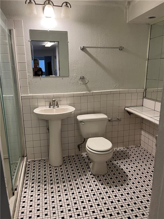 67 Barry Street Pittsburgh, PA 15203 - Photo 14 of 17 a bathroom with a toilet a sink and a mirror