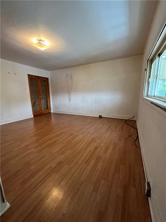 67 Barry Street Pittsburgh, PA 15203 - Photo 8 of 17 an empty room with wooden floor and windows
