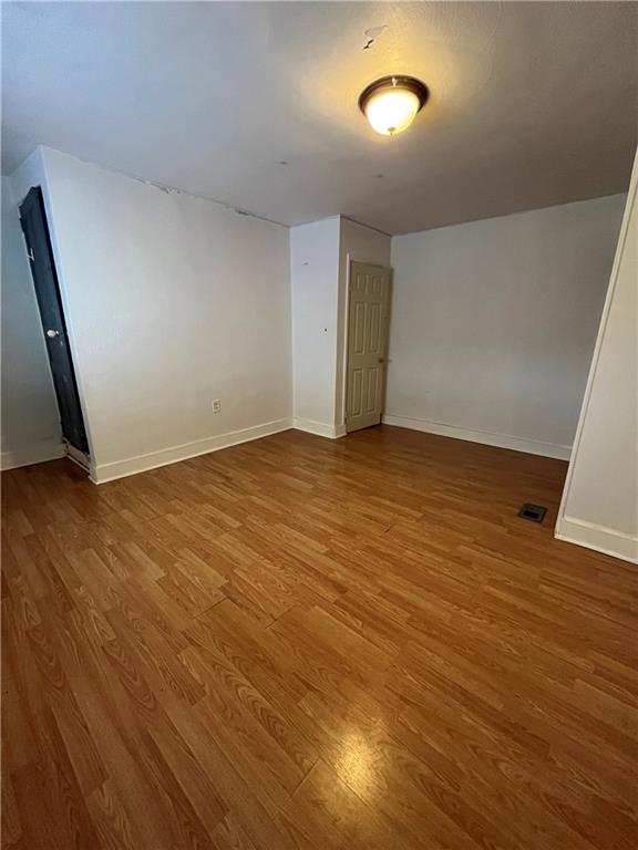 67 Barry Street Pittsburgh, PA 15203 - Photo 9 of 17 an empty room with wooden floor and entrance