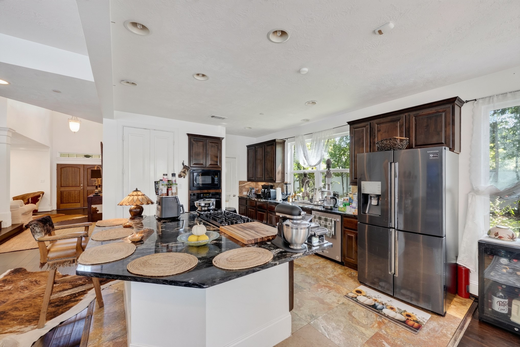 335 Voss Road Houston, TX 77024 - Photo 14 of 50 Designed for both everyday living and entertaining, this gourmet kitchen offers extensive red marble countertop, premium finishes, and seamless flow to surrounding living areas.