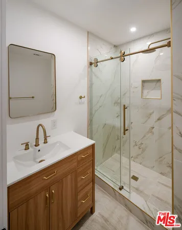 a bathroom with a shower sink mirror and shower