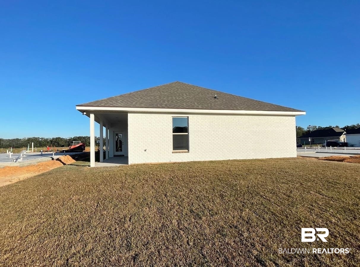 1363 Fenton Circle Foley, AL 36535 - Photo 18 of 20 Back of house featuring a lawn