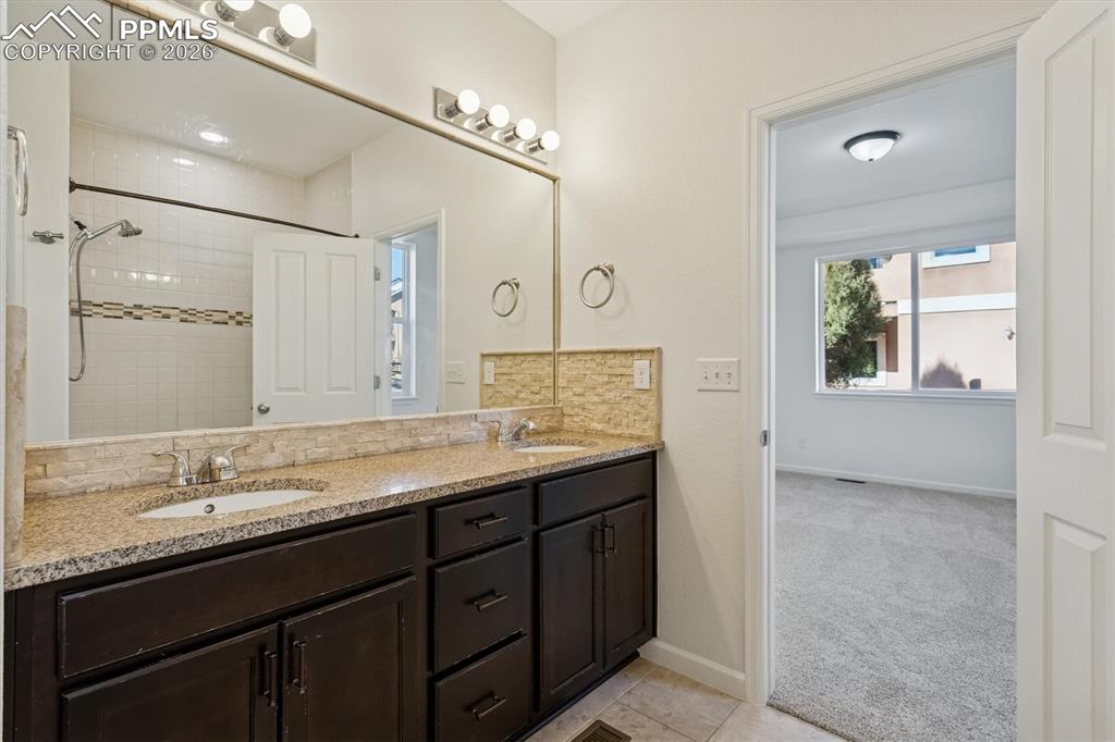 960 Fire Rock Place Colorado Springs, CO 80921 - Photo 12 of 30 a bathroom with a granite countertop sink mirror and double