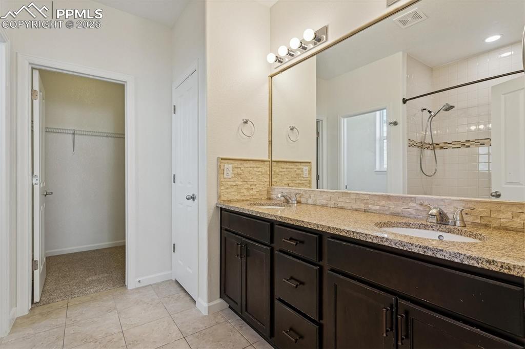 960 Fire Rock Place Colorado Springs, CO 80921 - Photo 14 of 30 a bathroom with a granite countertop sink mirror and double