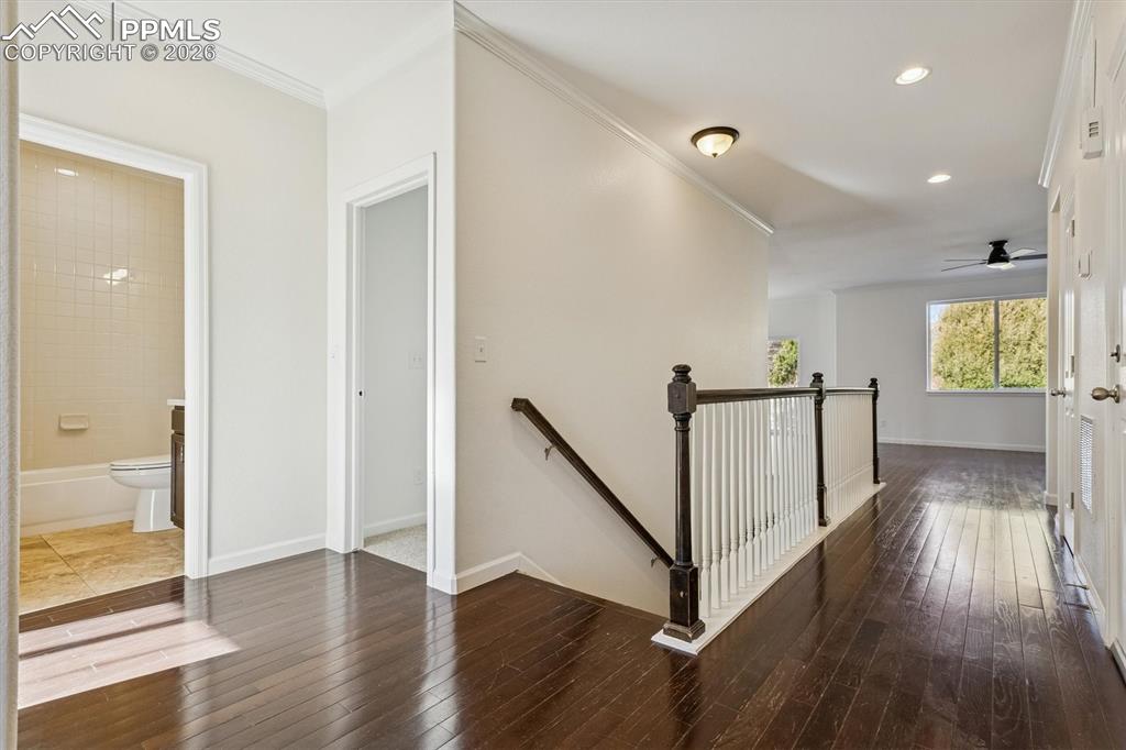 960 Fire Rock Place Colorado Springs, CO 80921 - Photo 2 of 30 a view of a hallway with wooden floor and stairs