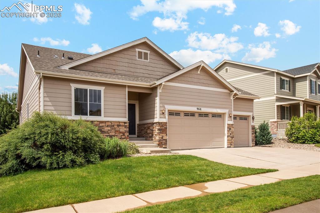 960 Fire Rock Place Colorado Springs, CO 80921 - Photo 5 of 30 a front view of a house with a yard and garage