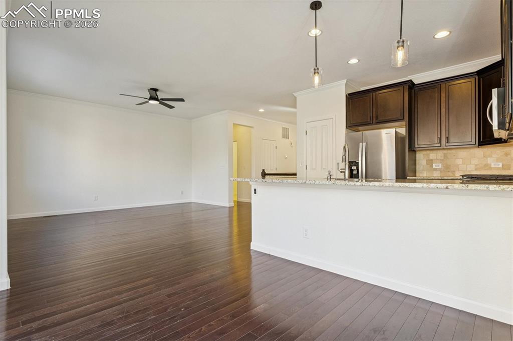 960 Fire Rock Place Colorado Springs, CO 80921 - Photo 6 of 30 a view of kitchen with stainless steel appliances refrigerator stove microwave and cabinets