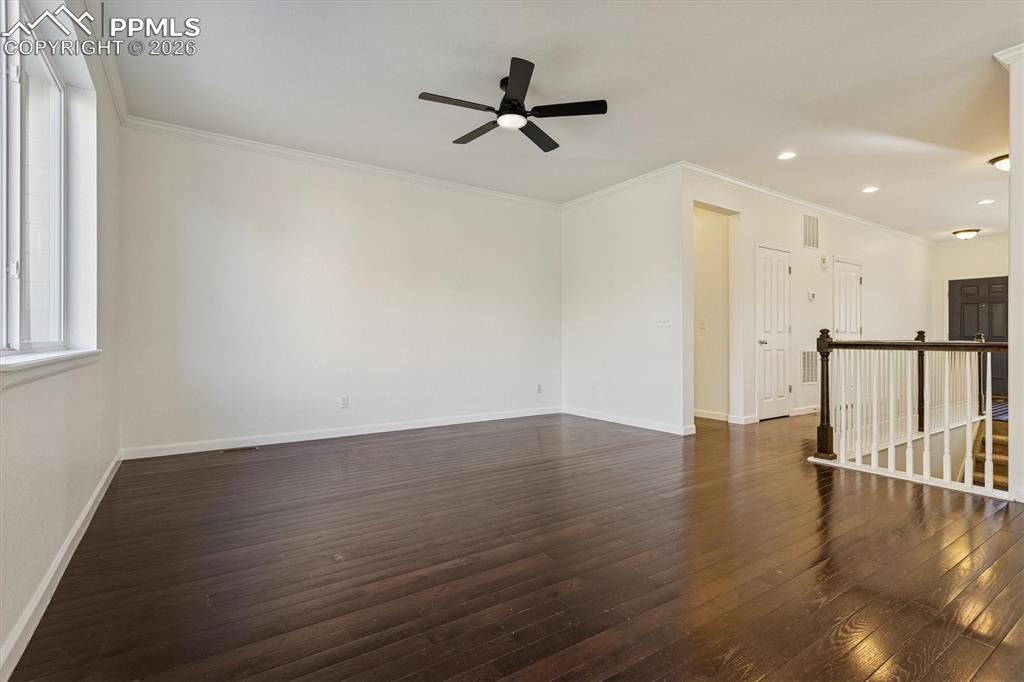 960 Fire Rock Place Colorado Springs, CO 80921 - Photo 8 of 30 a view of a livingroom with wooden floor and a ceiling fan