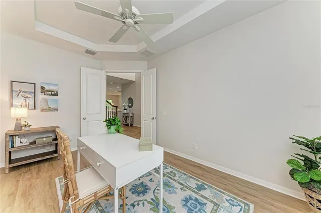 a view of a dining room with furniture a chandelier and wooden floor