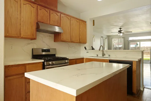 a kitchen with a sink a stove and cabinets