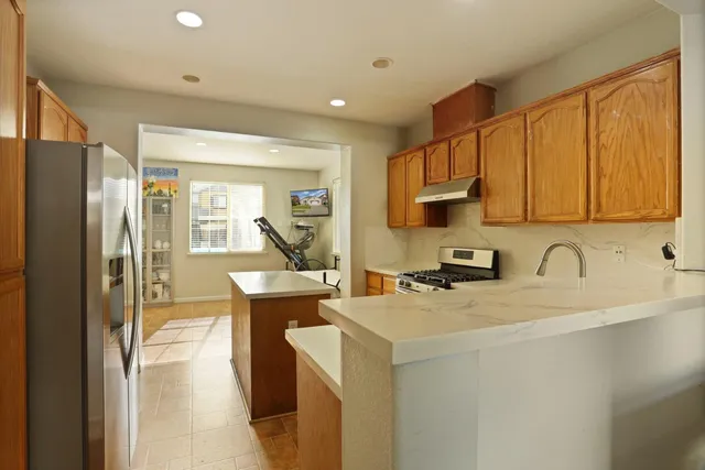 a kitchen with a sink a stove and refrigerator