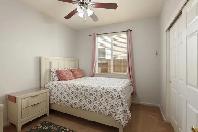 a bedroom with a bed and window