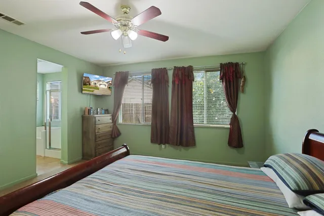 a bedroom with a bed and a window