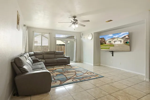 a living room with furniture and a painting on the wall