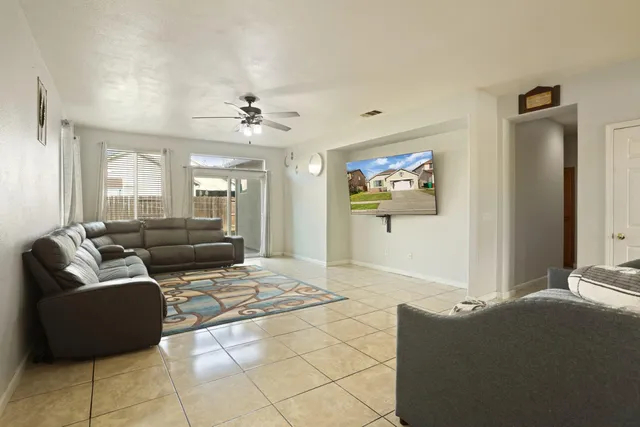 a living room with furniture and a chandelier