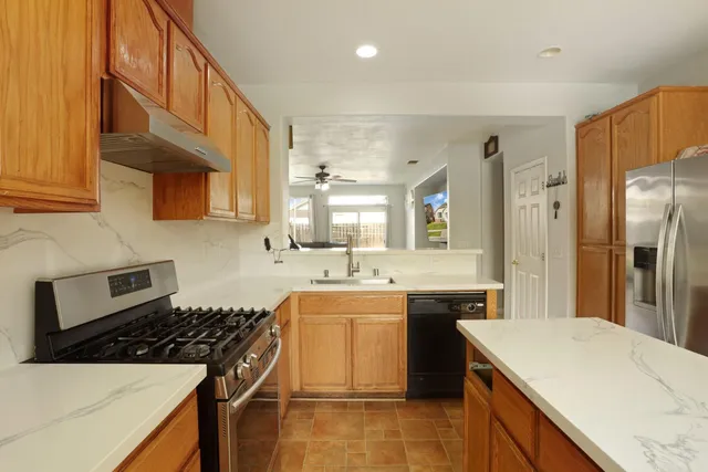 a kitchen with a sink a stove and refrigerator