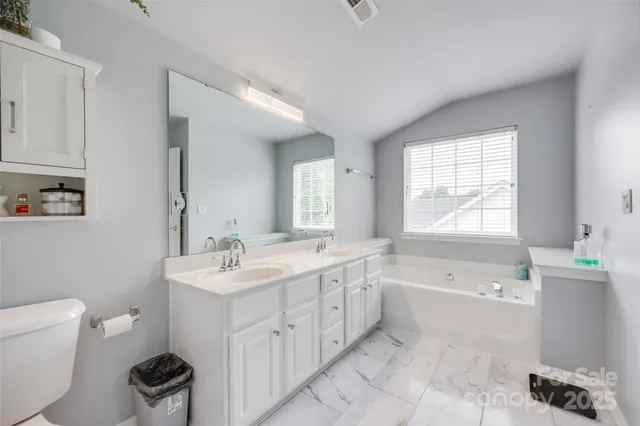 a bedroom with a bed and a large mirror