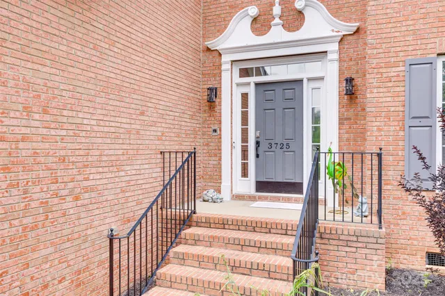 a view of a brick house with a door and wooden floor