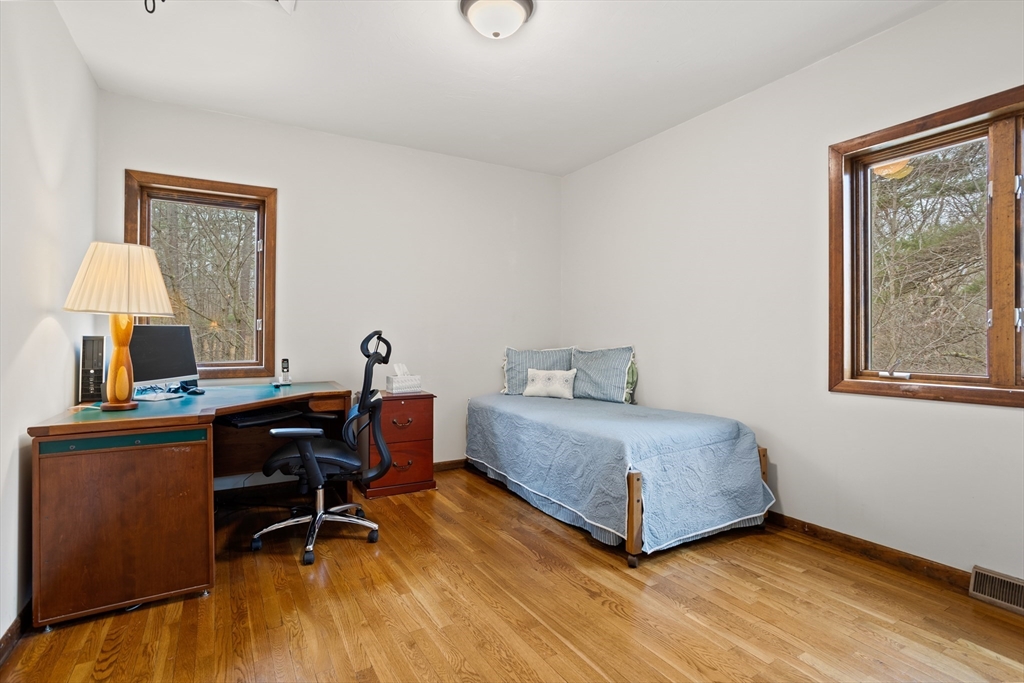 88 Coventry Wood Road Bolton, MA 01740 - Photo 22 of 41 a view of a workspace with furniture and a window